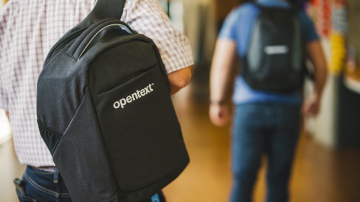 Person carrying an OpenText backpack