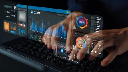 A person interacting with holographic data dashboards and charts projected