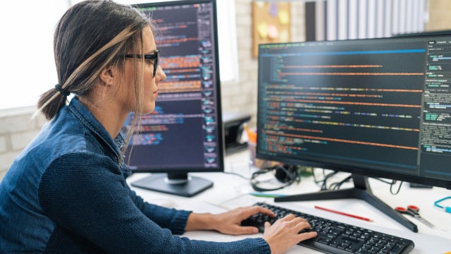 a person looking at code on a monitor