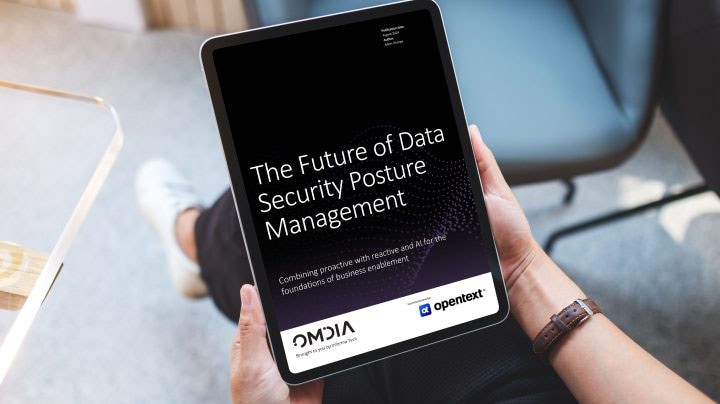 Person holding tablet and viewing the Omdia report, “The Future of Data Security Posture Management” commissioned by OpenText
