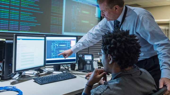 2 co-workers looking at computer monitors