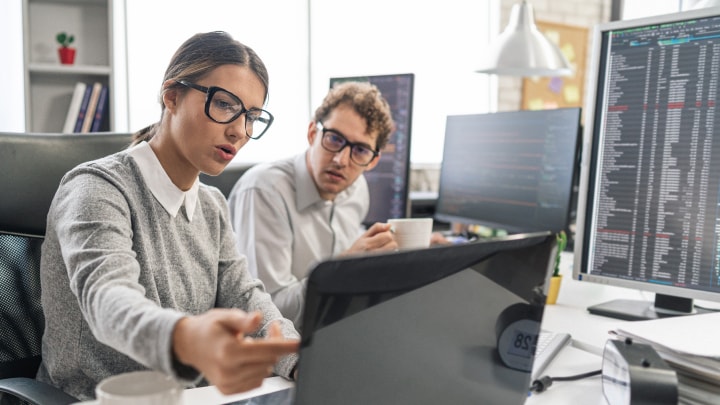 Two people looking at a monitor