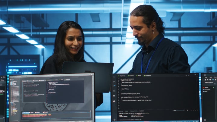 two co-workers looking at a tablet