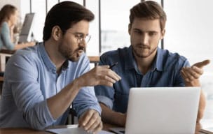 Two people working on a laptop