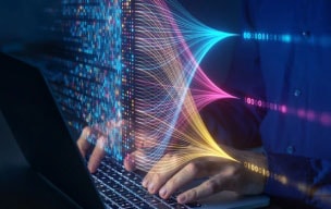 Person in security operations typing on a laptop