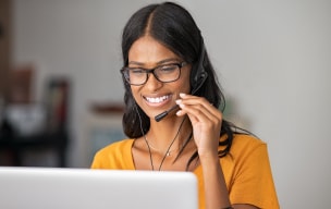 Person smiling while on phone headset