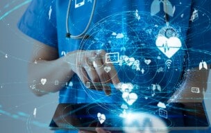Healthcare professional using a tablet with digital health icons.