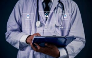 Medical professional holding a tablet with digital health icons.