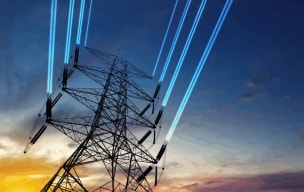 Worker standing on top of wind turbine