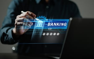 A person using stylus on their laptop with a digital banking icon