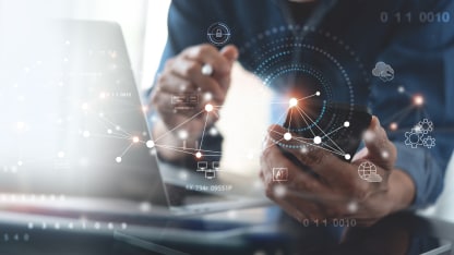 Hands gesturing in front of a laptop screen