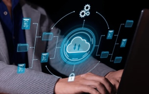 Digital cloud files icons with a person working on a laptop in the background