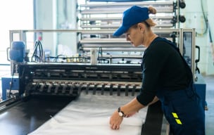 Worker operating packaging equipment