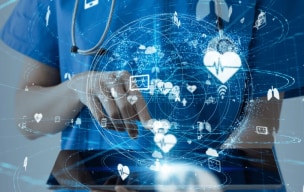 A doctor working on a screen with some digital healthcare icons on the front