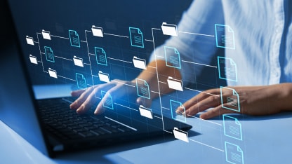 A lot of virtual folder icons with a person using a laptop in the background