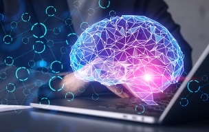 A virtual brain image with a person working on laptop in the background