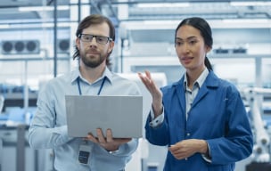 Two manufacturing professionals discussing data