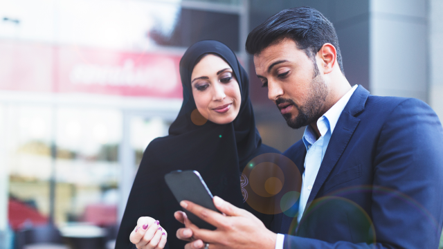 two people looking at a phone