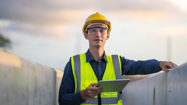 Construction worker holding a tablet