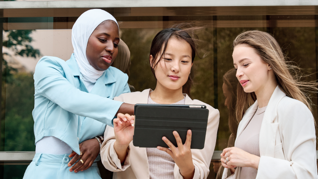 Three business people reviewing something on the tablet