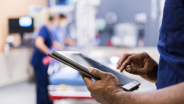 The person using digital tablet in operation room