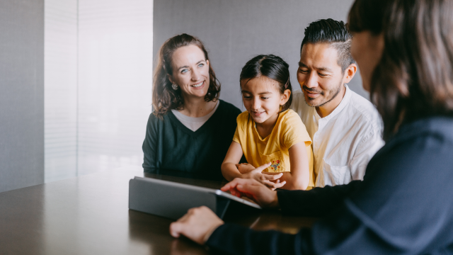 A family reviewing a tablet