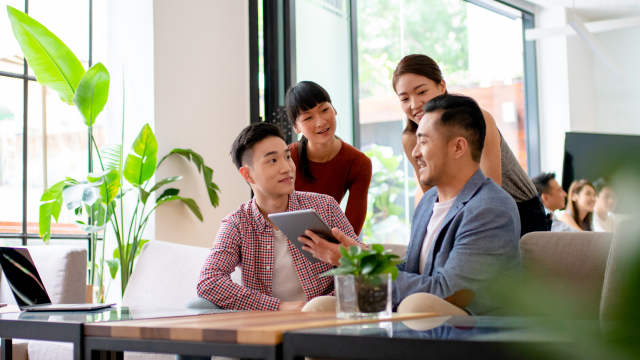 Group of colleagues looking at a tablet