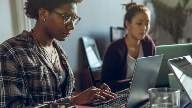 two person looking at computer