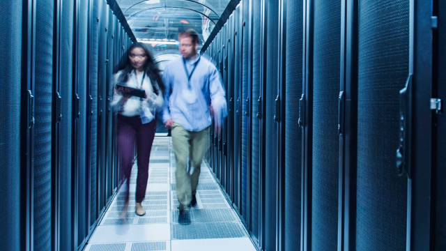 Two people conversing in the data storage area 