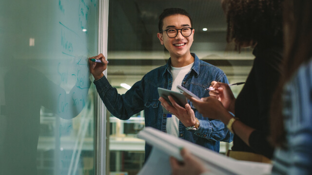 A person writing in whiteboard
