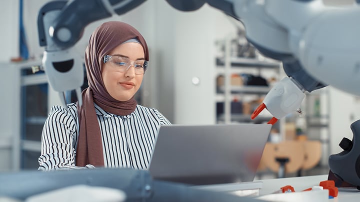 Woman working at a laptop in lab