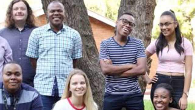 college students looking at camera with smiles