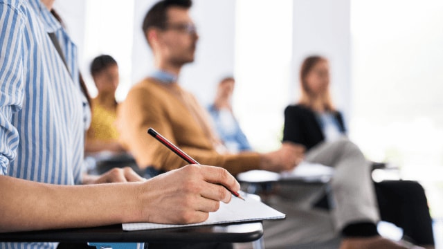 people listening to a lecture in class