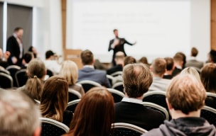 A group of people in an auditorium watching a breakout session