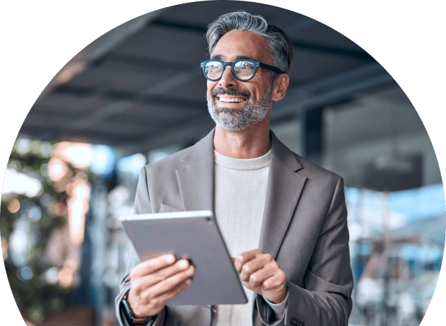 A person smiling using a tablet.