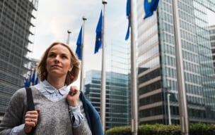 Person standing infront of the EU headquarters