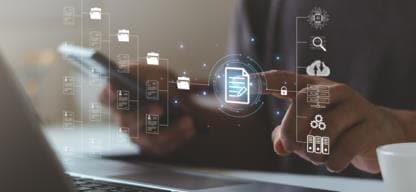 Person working on laptop and mobile phone